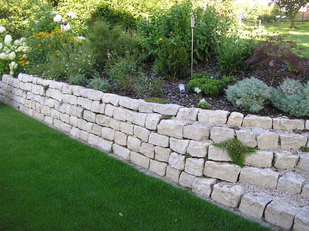 Eine Mauer aus hellen Mauersteinen aus Jura Marmor